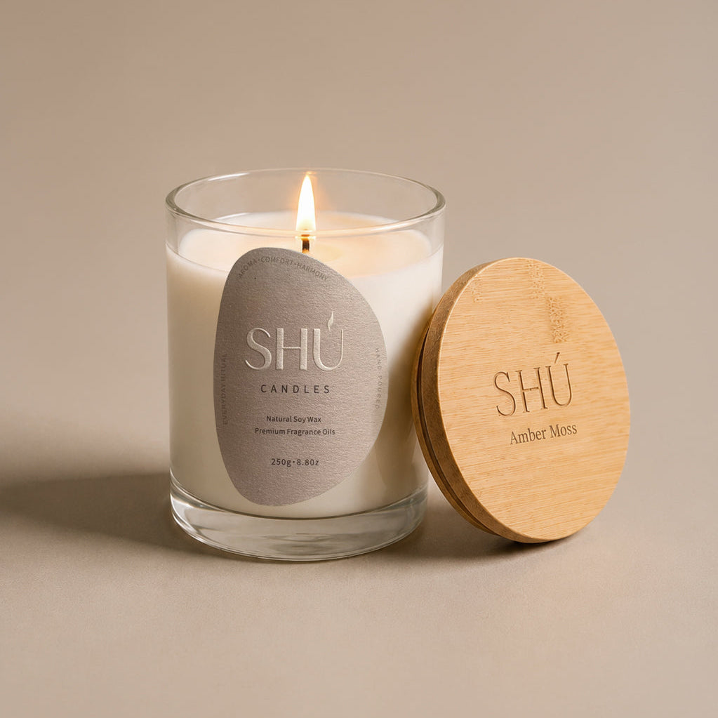 Amber Moss soy candle in clear glass with dark brown label, SHU Candles