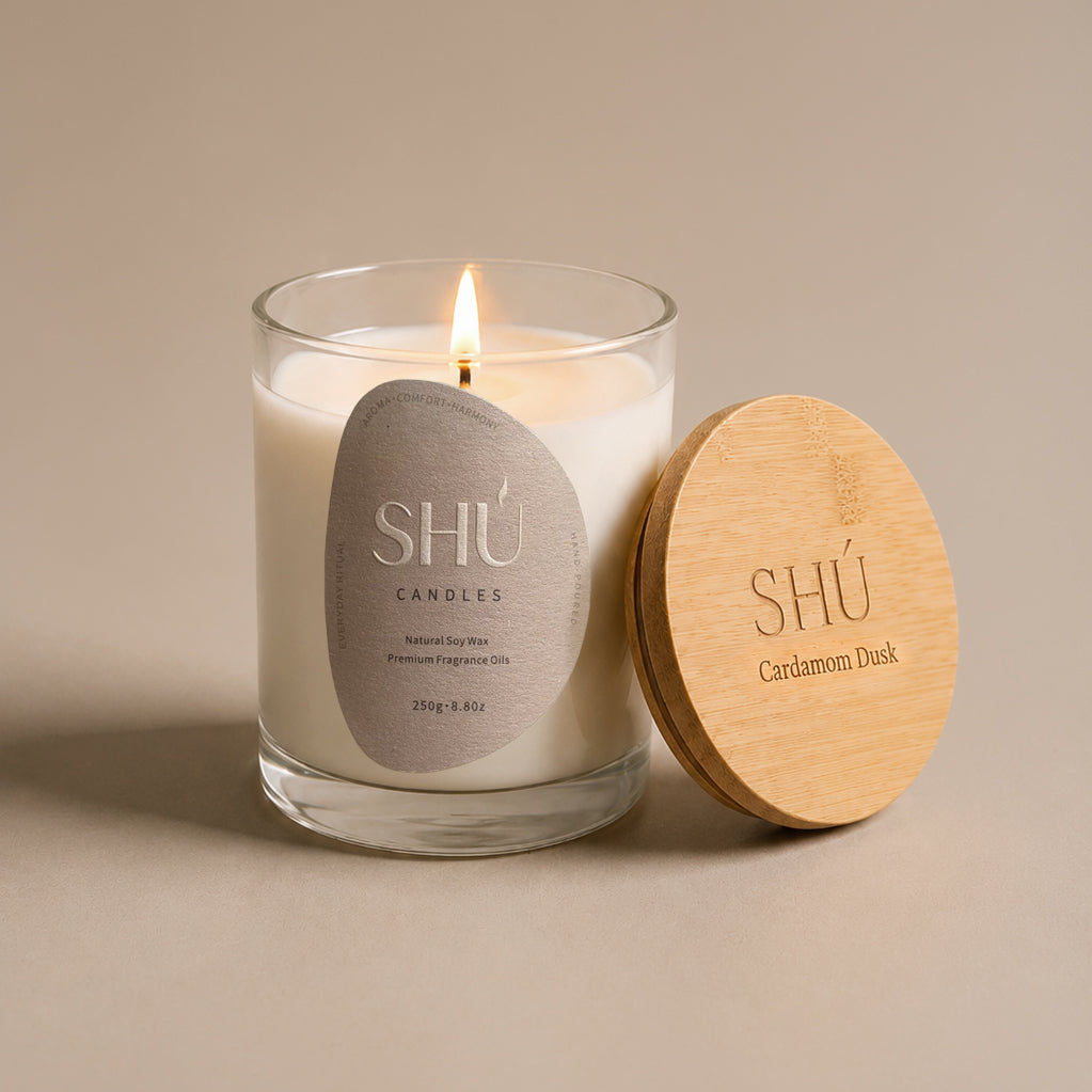 Cardamom Dusk soy candle in clear glass with dark brown label, SHU Candles