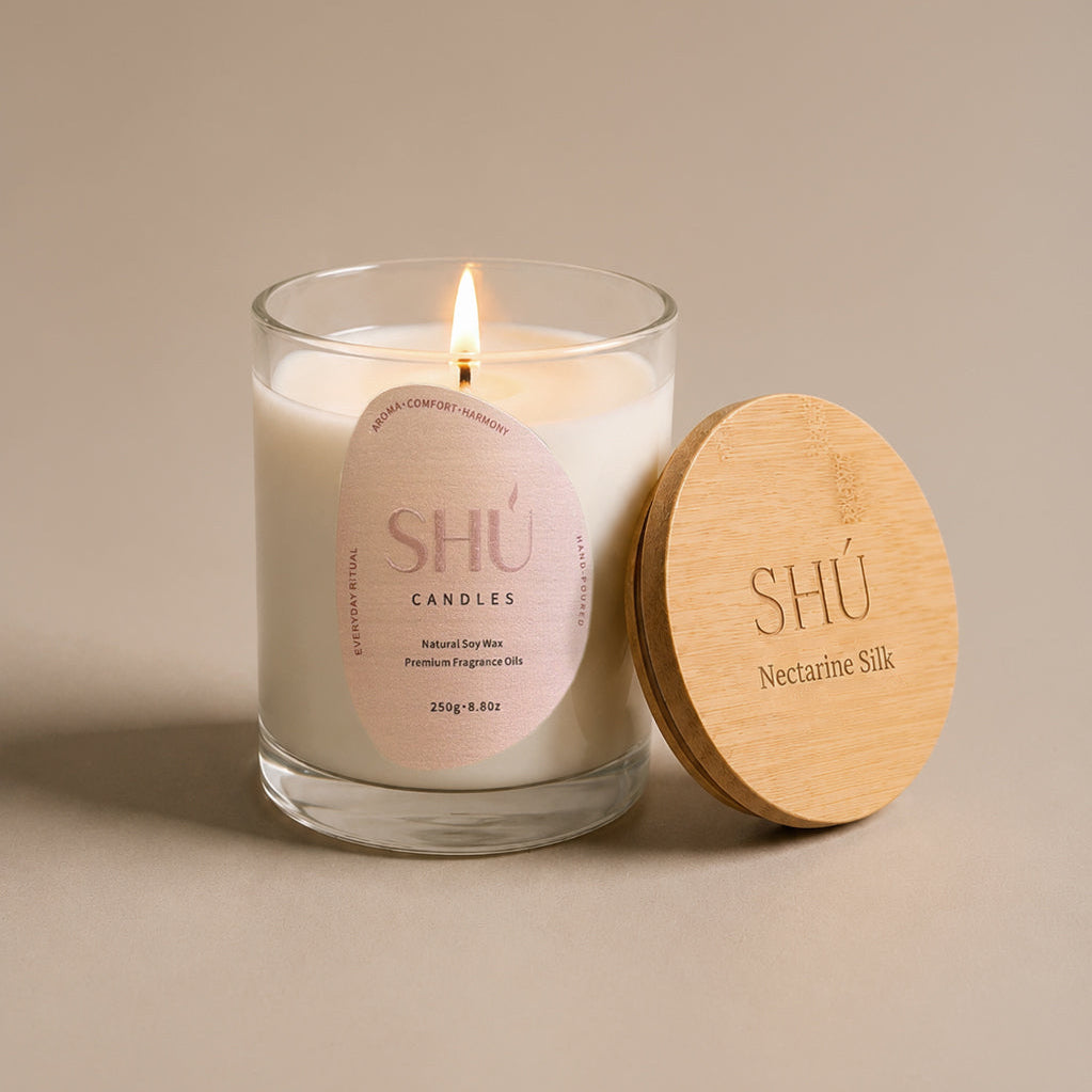 Nectarine Silk soy candle in clear glass with blush label, SHU Candles